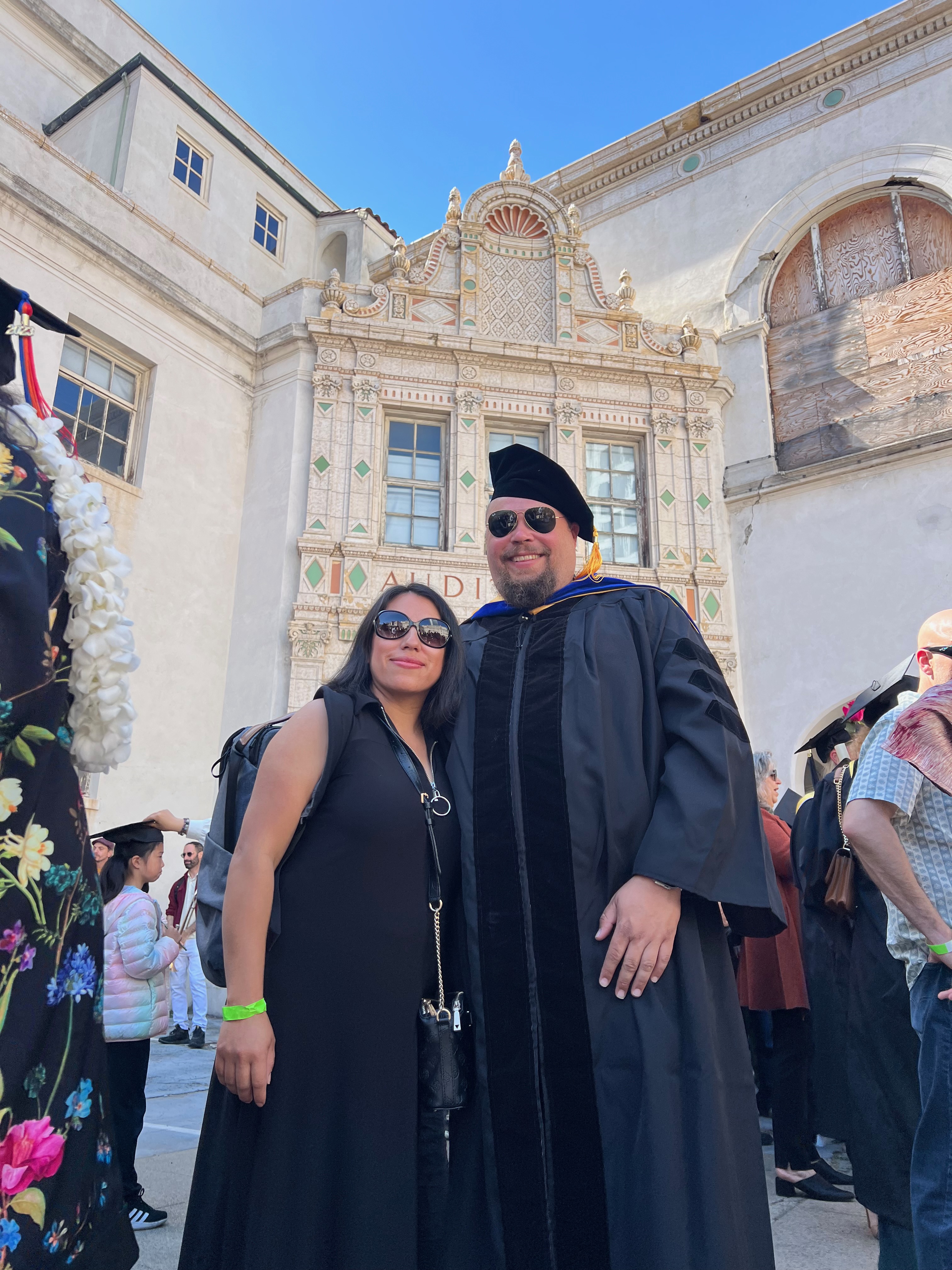 Photo of Jacob in his graduation regalia with Belinda in San Francisco