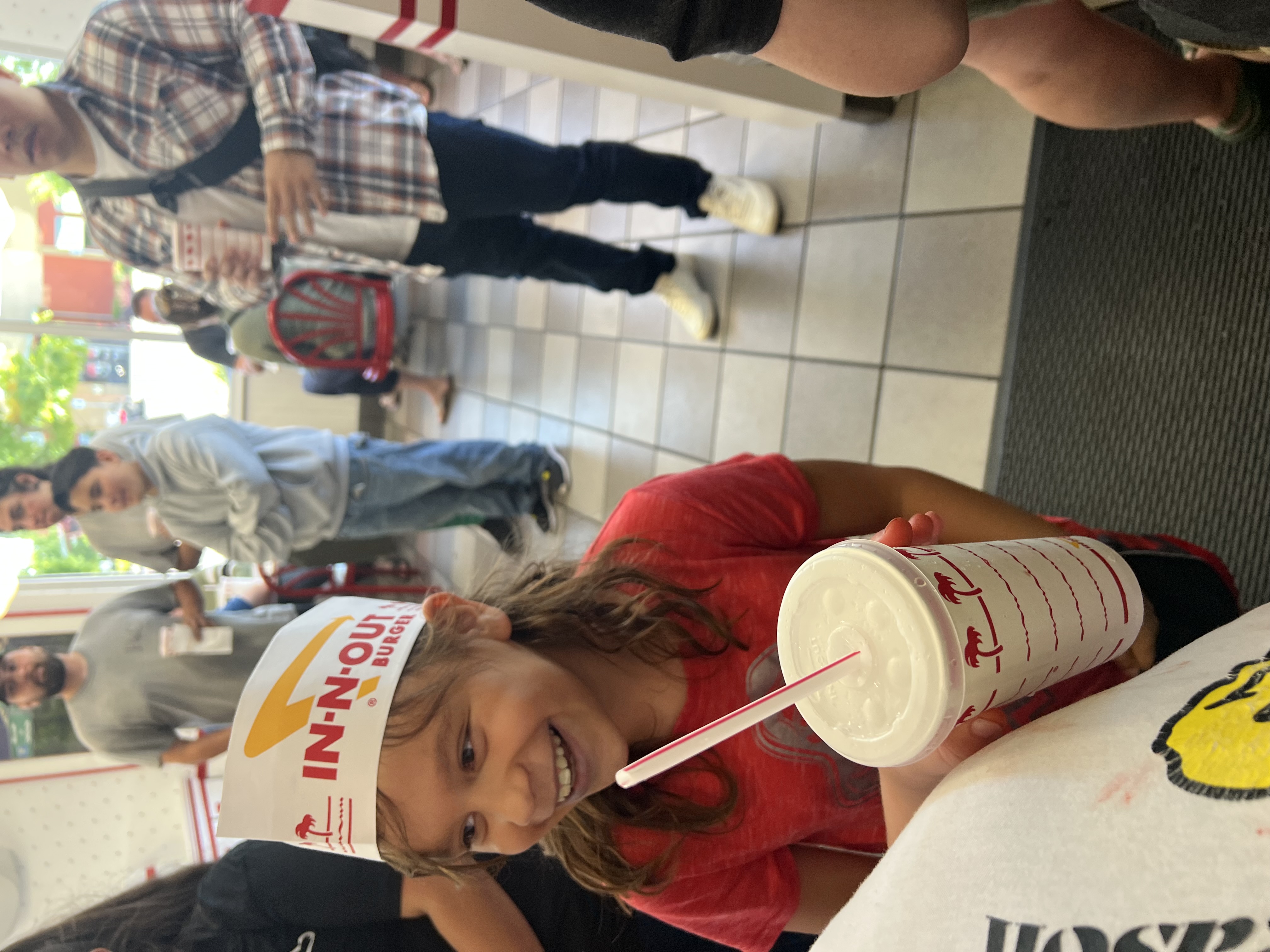 photo of a girl wearing an In-N-Out Burger hat