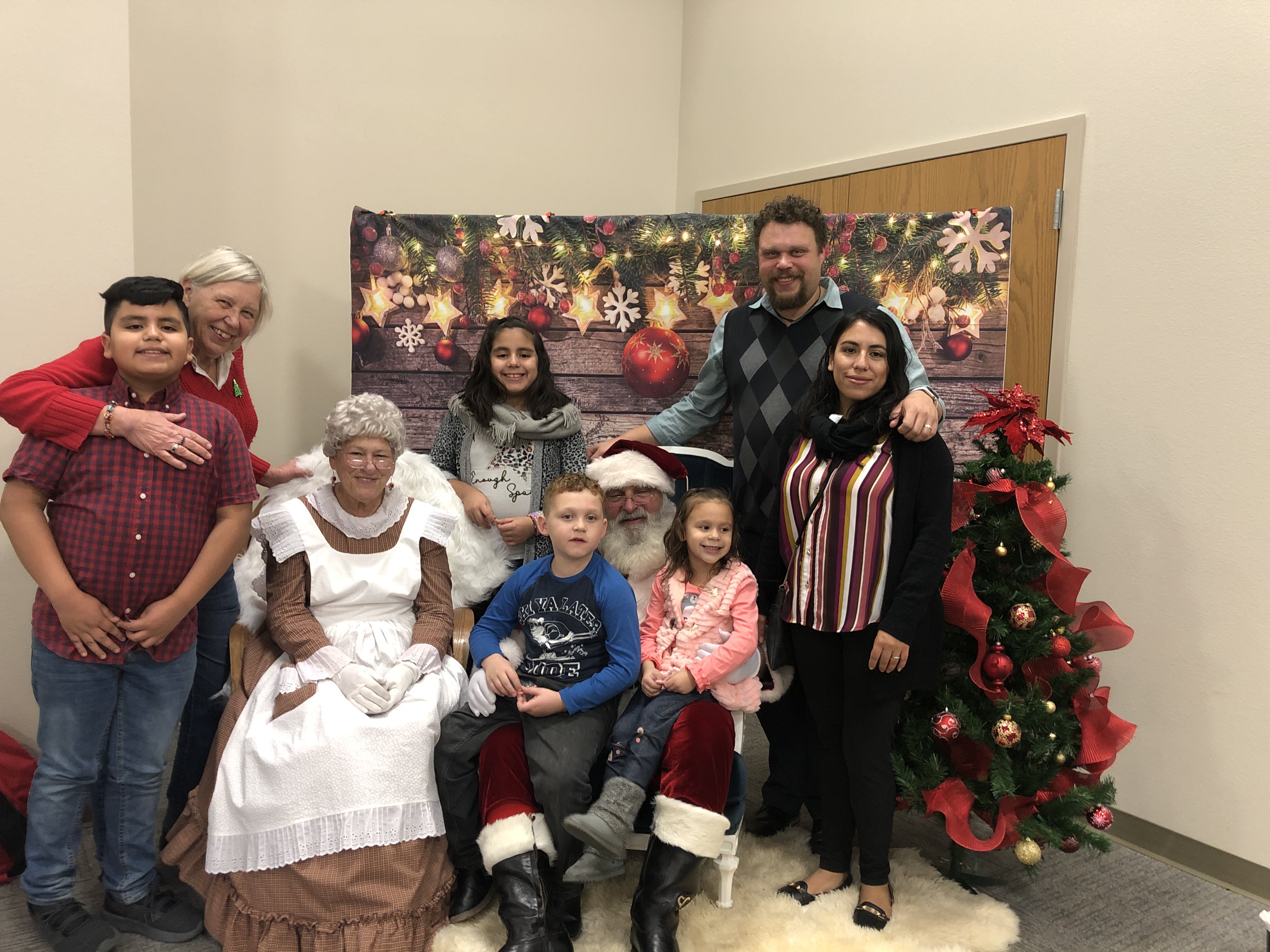 A photo of my family posing with Santa Clause at the EFH 2019 Christmas Party