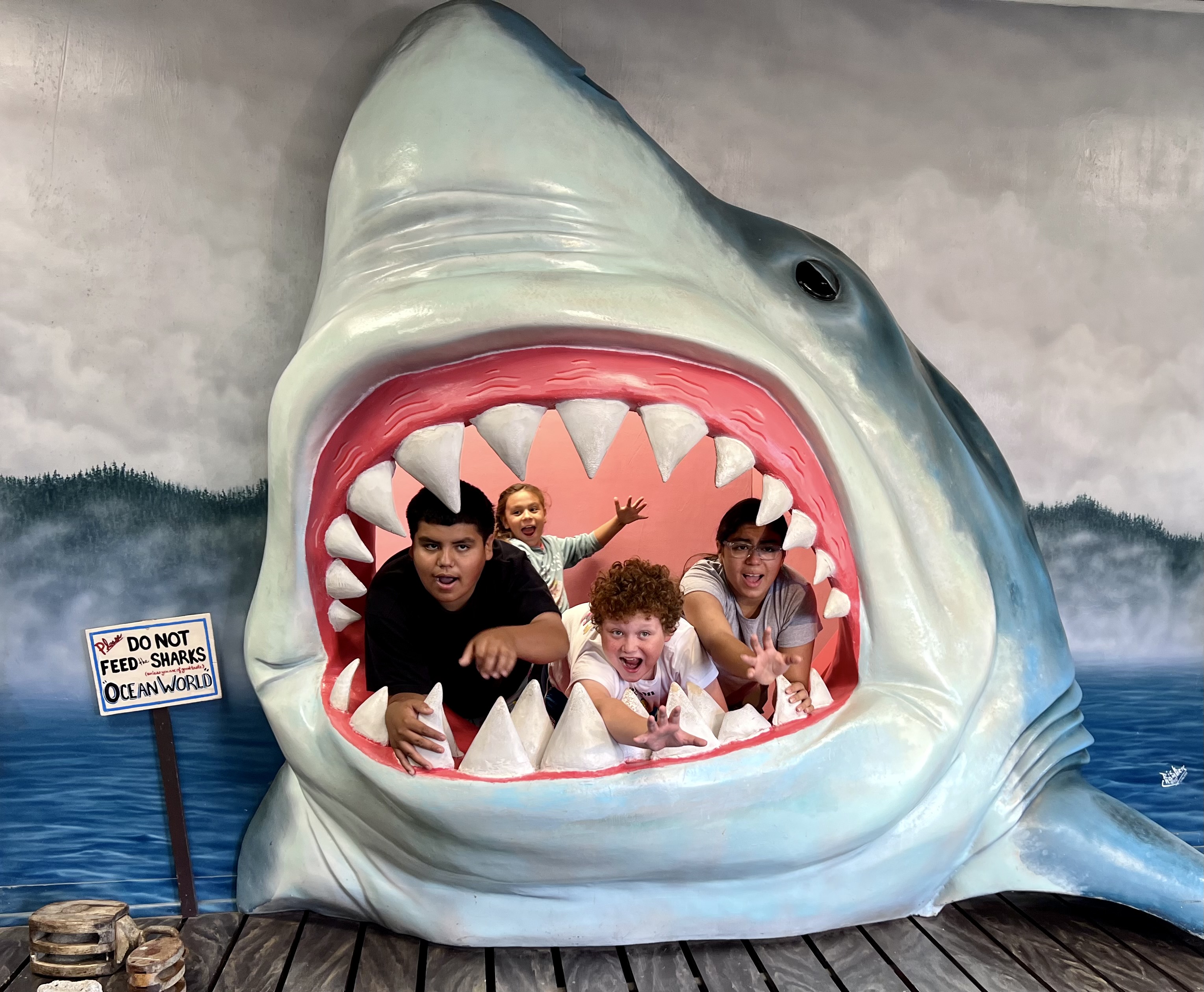 My kids, Alex, Alexa, Mateo, Arianna inside a fake shark mouth at Ocean World