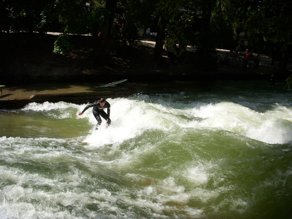  A photo of a guy surfing at Englisher Garten. The Englischer Garten, German for 