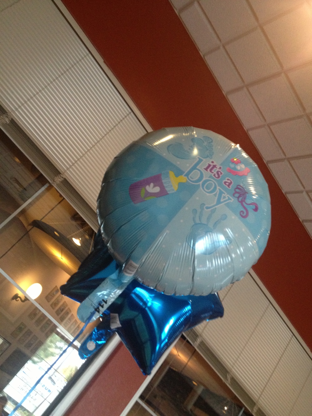 A photo taken at  Tony Romas for our  Baby Shower. It displays a photo of a balloon that was at our baby shower with the words “It’s a Boy” written on it. 